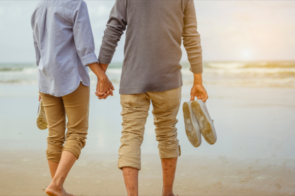 happily retired couple going to the beach