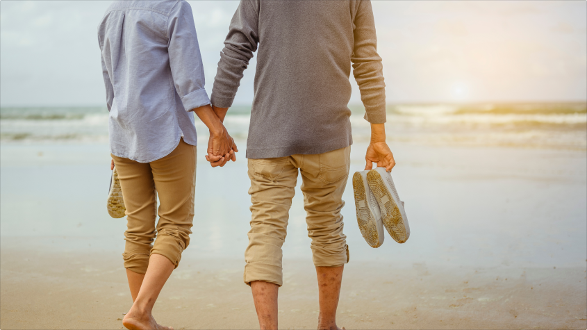 happily retired couple going to the beach